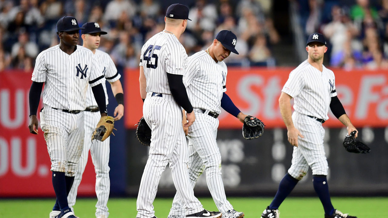 NEW YORK, NEW YORK - SEPTEMBER 20: Gleyber Torres #25 of the New York Yankees gets up and walks with his teammates after sliding in the outfield grass while fielding a ball during the fourth inning of their game against the Toronto Blue Jays at Yankee Stadium on September 20, 2019 in the Bronx borough of New York City. Torres exited the game in the sixth inning.