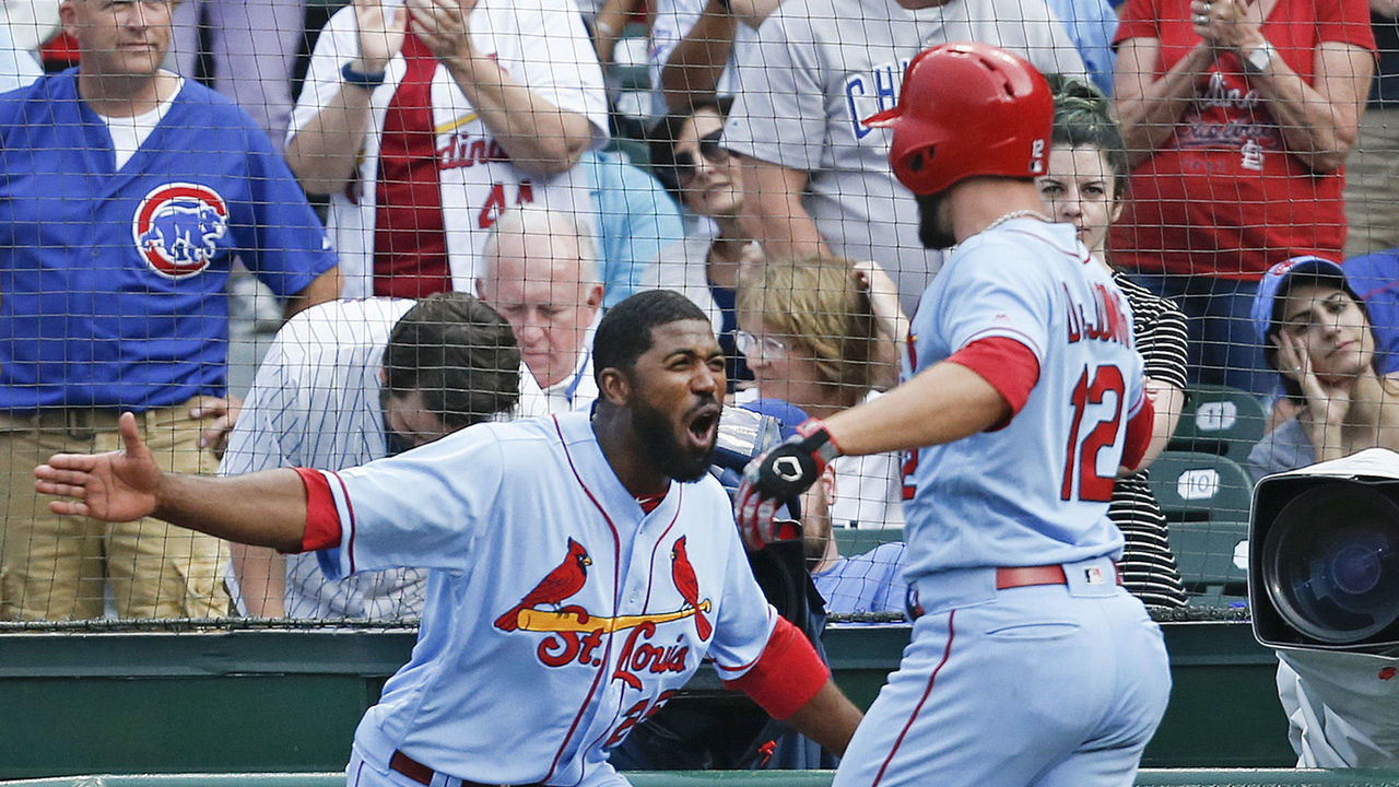 CHICAGO, ILLINOIS - SEPTEMBER 21: Paul DeJong #12 of the St. Louis Cardinals is congratulated by Dexter Fowler #25 following his solo home run during the ninth inning of a game against the Chicago Cubs at Wrigley Field on September 21, 2019 in Chicago, Illinois.