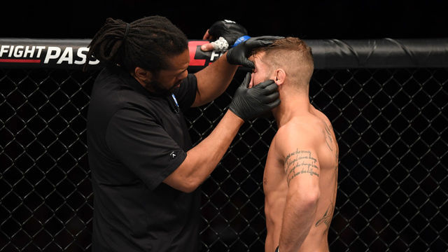 MEXICO CITY, MEXICO - SEPTEMBER 21: Referee Herb Dean inspects the eye of Jeremy Stephens after an accidental eye poke in his featherweight bout against Yair Rodriguez of Mexico during the UFC Fight Night event on September 21, 2019 in Mexico City, Mexico.