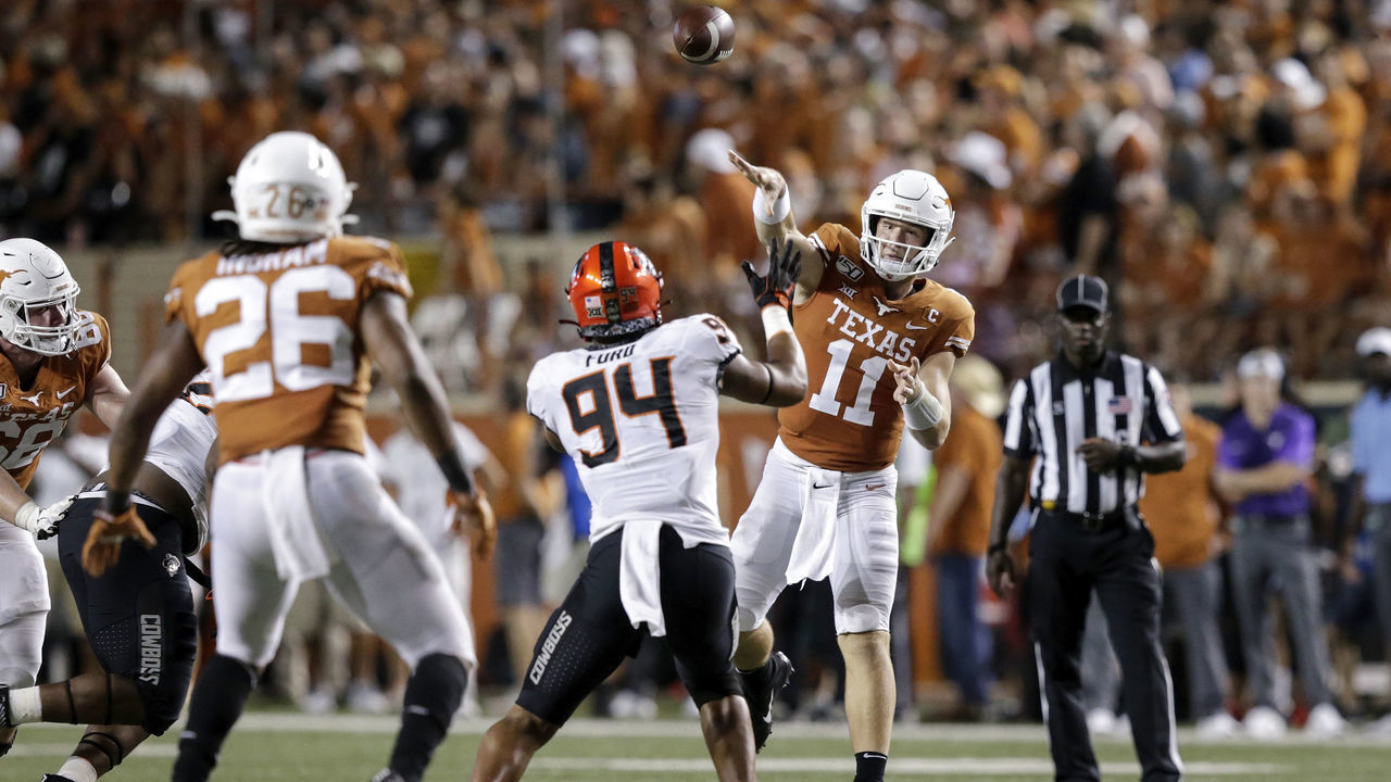 AUSTIN, TX - SEPTEMBER 21: Sam Ehlinger #11 of the Texas Longhorns throws a pass in the fourth quarter defended by Trace Ford #94 of the Oklahoma State Cowboys at Darrell K Royal-Texas Memorial Stadium on September 21, 2019 in Austin, Texas.