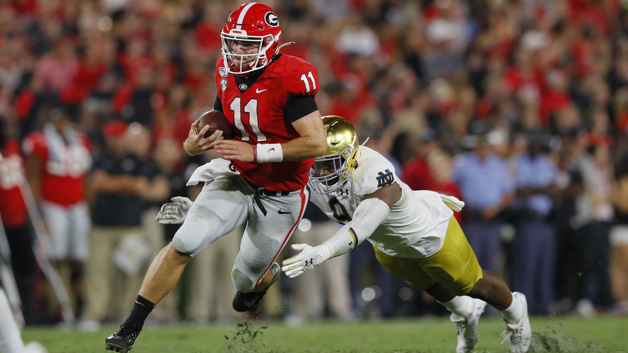 ATHENS, GEORGIA - SEPTEMBER 21: Jake Fromm #11 of the Georgia Bulldogs tires to outrun the tackle by Lewis Cine #8 of the Georgia Bulldogs during the second half at Sanford Stadium on September 21, 2019 in Athens, Georgia.