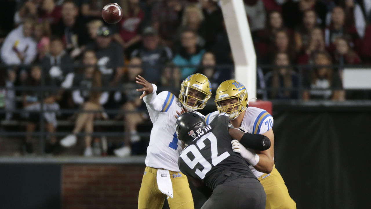 PULLMAN, WASHINGTON - SEPTEMBER 21: Quarterback Dorian Thompson-Robinson #1 of the UCLA Bruins throws a pass and is protected by Alec Anderson #70 against Will Rodgers III #92 of the Washington State Cougars in the first half at Martin Stadium on September 21, 2019 in Pullman, Washington.