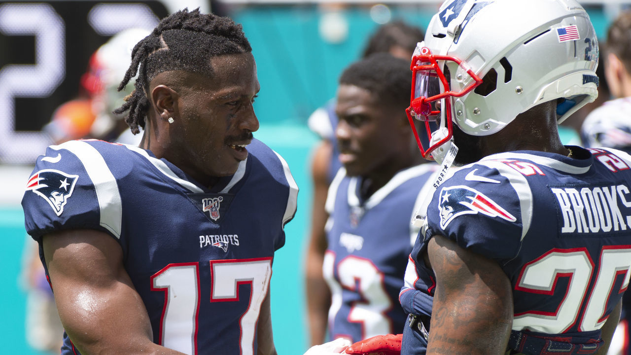 MIAMI GARDENS, FL - SEPTEMBER 15: New England Patriots Wide Receiver Antonio Brown (17) shakes hands with New England Patriots Safety Terrence Brooks (25) before the start of the NFL game between the New England Patriots and the Miami Dolphins at the Hard Rock Stadium in Miami Gardens, Florida on September 15, 2019.