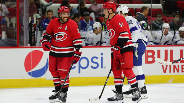 RALEIGH, NC - SEPTEMBER 18: Carolina Hurricanes defenseman Justin Faulk (27) smiling with Carolina Hurricanes defenseman Jake Gardiner (51) during the 2nd period of the Carolina Hurricanes game versus the Tampa Bay Lightning on September 18th, 2019 at PNC Arena in Raleigh, NC.