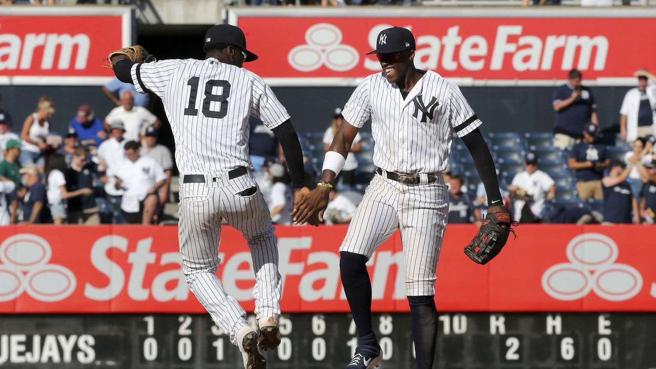 NEW YORK, NEW YORK - SEPTEMBER 21: Didi Gregorius #18 and Cameron Maybin #38 of the New York Yankees celebrate after defeating the Toronto Blue Jays at Yankee Stadium on September 21, 2019 in New York City.