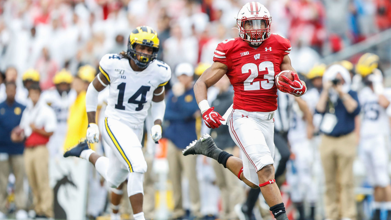 MADISON, WI - SEPTEMBER 21: Wisconsin running back Jonathan Taylor (23) runs away from Michigan defensive back Josh Metellus (14) to score a touchdown during a Big Ten college football game between the University of Wisconsin Badgers and the University Michigan Wolverines on September 21, 2019 at Camp Randall Stadium in Madison, WI.