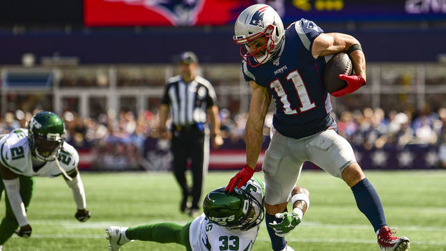 FOXBOROUGH, MA - SEPTEMBER 22: Julian Edelman #11 of the New England Patriots evades a tackle by Jamal Adams #33 of the New York Jets during the second quarter of a game at Gillette Stadium on September 22, 2019 in Foxborough, Massachusetts.