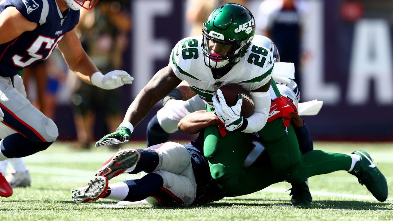 FOXBOROUGH, MASSACHUSETTS - SEPTEMBER 22: Le'Veon Bell #26 of the New York Jets is tackled by the New England Patriots during the first quarter in the game at Gillette Stadium on September 22, 2019 in Foxborough, Massachusetts.