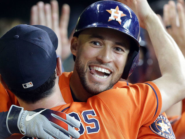 HOUSTON, TEXAS - SEPTEMBER 22: George Springer #4 of the Houston Astros celebrates with Garrett Stubbs #11 after hitting a two-run home run in the second inning against the Los Angeles Angels at Minute Maid Park on September 22, 2019 in Houston, Texas.