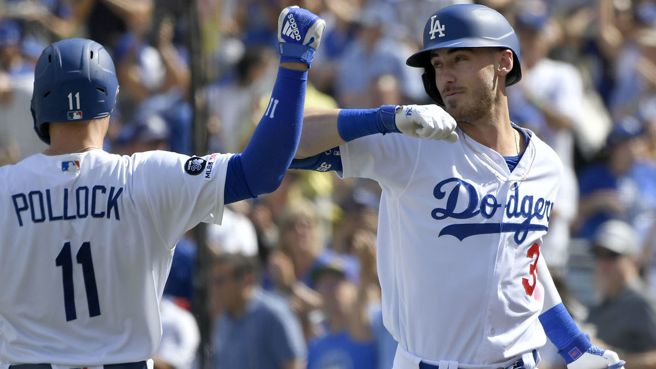 LOS ANGELES, CA - SEPTEMBER 22: A.J. Pollock #11 of the Los Angeles Dodgers congratulates Cody Bellinger #35 for his grand slam home run against the Colorado Rockies in the fifth inning at Dodger Stadium on September 22, 2019 in Los Angeles, California.