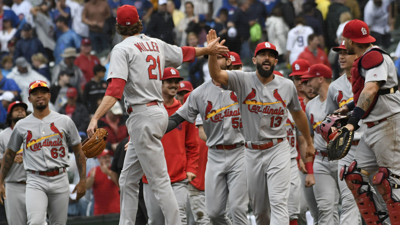 CHICAGO, ILLINOIS - SEPTEMBER 22: Andrew Miller #21 of the St. Louis Cardinals and Matt Carpenter #13 celebrate their 3-2 win against the Chicago Cubs at Wrigley Field on September 22, 2019 in Chicago, Illinois.