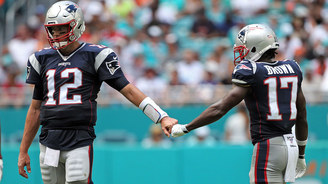 MIAMI , MA. - SEPTEMBER 15: Tom Brady #12 and Antonio Brown #17 of the New England Patriots bump fists during the second quarter of the NFL game against the Miami Dolphins at the Hard Rock Stadium on September 15, 2019 in Miami , Florida. (Staff Photo By Matt Stone/MediaNews Group/Boston Herald)