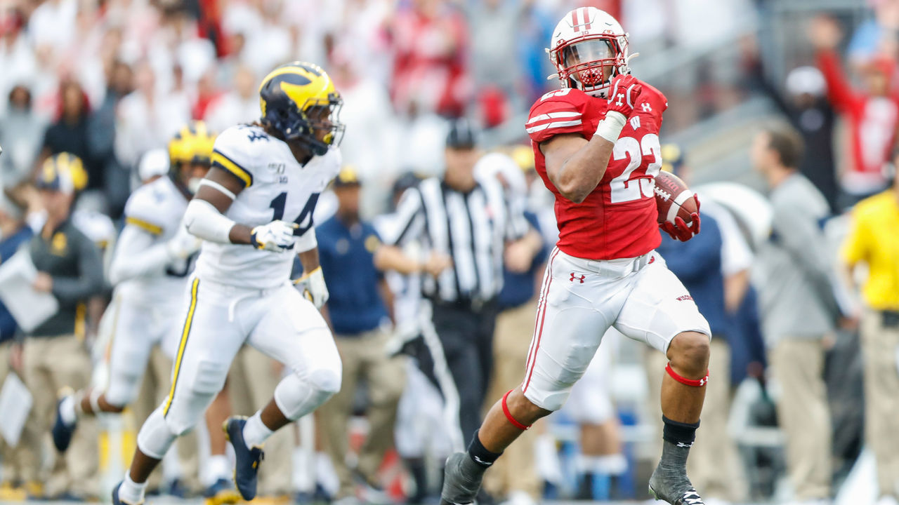 MADISON, WI - SEPTEMBER 21: Wisconsin running back Jonathan Taylor (23) runs away from Michigan defensive back Josh Metellus (14) to score a touchdown during a Big Ten college football game between the University of Wisconsin Badgers and the University Michigan Wolverines on September 21, 2019 at Camp Randall Stadium in Madison, WI.