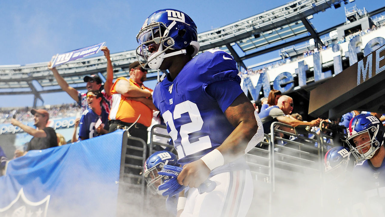 EAST RUTHERFORD, NEW JERSEY - SEPTEMBER 15: Wayne Gallman #22 of the New York Giants runs onto the field before the start of the game against the Buffalo Bills at MetLife Stadium on September 15, 2019 in East Rutherford, New Jersey.