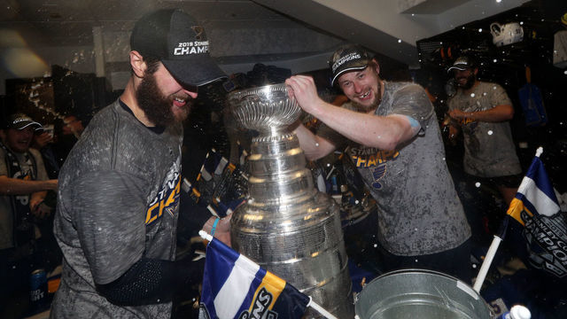 BOSTON, MASSACHUSETTS - JUNE 12: Robert Bortuzzo #41 of the St. Louis Blues pours a drink in the Stanley Cup as the St. Louis Blues celebrate in the locker room with the Stanley Cup after the 2019 NHL Stanley Cup Final at TD Garden on June 12, 2019 in Boston, Massachusetts. The St. Louis Blues defeated the Boston Bruins 4-1 in Game 7 to win the Stanley Cup Final 4-3.