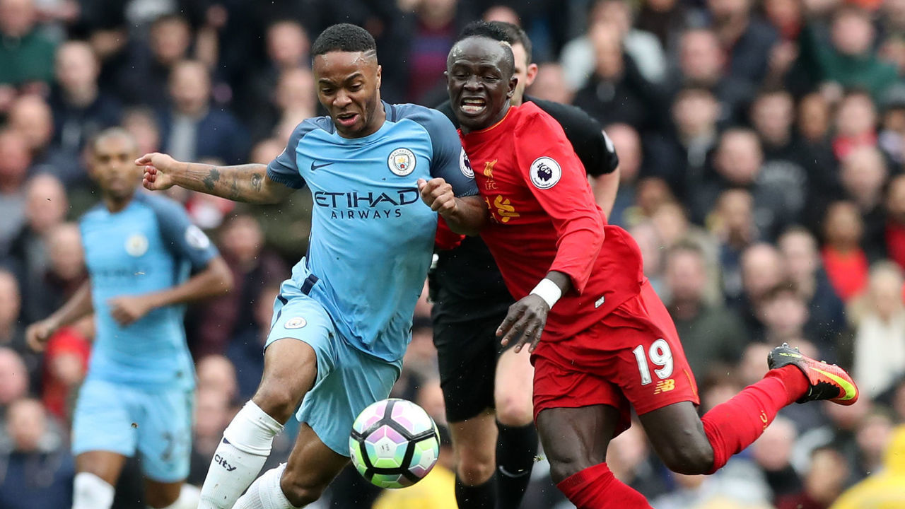 Manchester City's Raheem Sterling (left) and Liverpool's Sadio Mane battle for the ball during the Premier League match at the Etihad Stadium, Manchester.