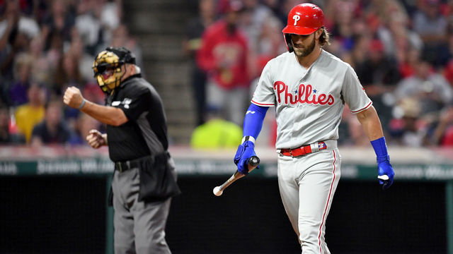 CLEVELAND, OHIO - SEPTEMBER 20: Home plate umpire Larry Vanover punches out Bryce Harper #3 of the Philadelphia Phillies after he struck out looking during the fourth inning at Progressive Field on September 20, 2019 in Cleveland, Ohio.