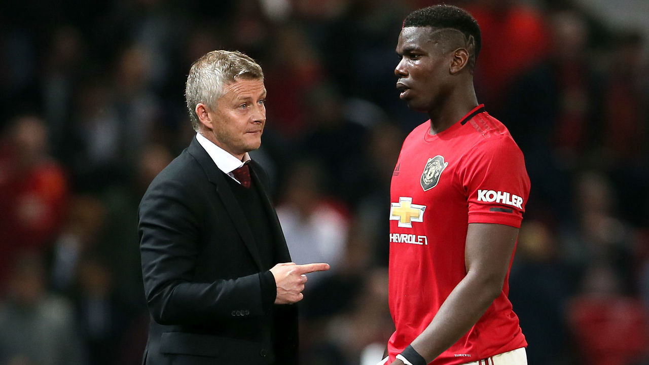Manchester United manager Ole Gunnar Solskjaer (left) and Paul Pogba during the Carabao Cup, Third Round match at Old Trafford, Manchester.