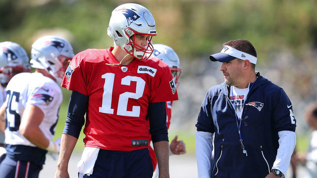 FOXBOROUGH, MA - SEPTEMBER 25: New England Patriots quarterback Tom Brady, left, and offensive coordinator Josh McDaniels chat during warmups at New England Patriots practice at Gillette Stadium in Foxborough, MA on Sep. 25, 2019.