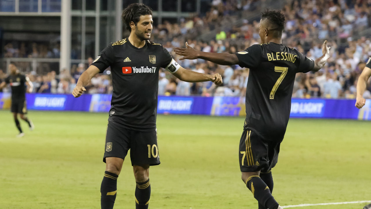 KANSAS CITY, KS - JULY 03: Los Angeles FC forward Latif Blessing (7) looks to hug forward Carlos Vela (10) after Vela scored a goal late in the second half of an MLS match between LAFC and Sporting Kansas City on July 03, 2019 at Children's Mercy Park in Kansas City, KS.
