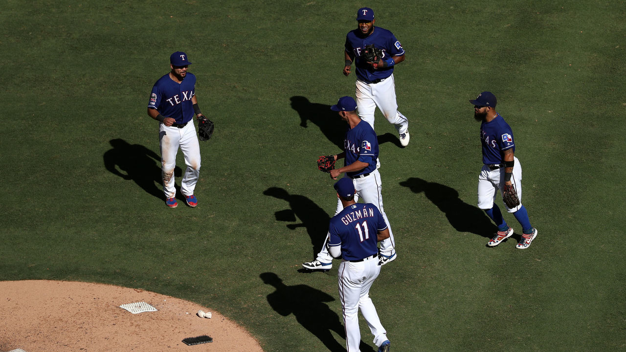 ARLINGTON, TEXAS - SEPTEMBER 26: (L-R) Isiah Kiner-Falefa #9, Elvis Andrus #1, Ronald Guzman #11 and Rougned Odor #12 surround Mike Minor #23 (center) after throwing his 200th strikeout of the season against the Boston Red Sox in the ninth inning at Globe Life Park in Arlington on September 26, 2019 in Arlington, Texas.