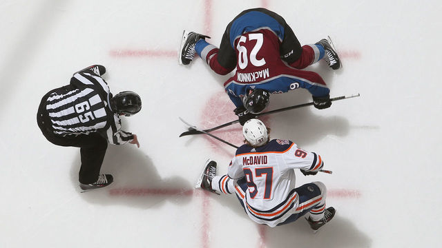 DENVER, CO - DECEMBER 11: Nathan MacKinnon #29 of the Colorado Avalanche faces off against Connor McDavid #97 of the Edmonton Oilers at the Pepsi Center on December 11, 2018 in Denver, Colorado. The Oilers defeated the Avalanche 6-4.