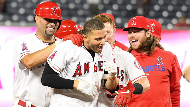 ANAHEIM, CA - SEPTEMBER 26: Los Angeles Angels shortstop Andrelton Simmons (2) celebrates with Los Angeles Angels first baseman Albert Pujols (5) after his hit won a MLB game between the Houston Astros and the Los Angeles Angels of Anaheim on September 26, 2019 at Angel Stadium of Anaheim in Anaheim, CA.