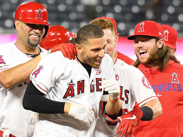ANAHEIM, CA - SEPTEMBER 26: Los Angeles Angels shortstop Andrelton Simmons (2) celebrates with Los Angeles Angels first baseman Albert Pujols (5) after his hit won a MLB game between the Houston Astros and the Los Angeles Angels of Anaheim on September 26, 2019 at Angel Stadium of Anaheim in Anaheim, CA.