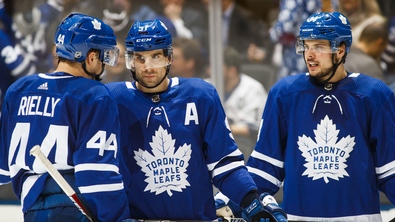 TORONTO, ON - JANUARY 7: John Tavares #91, Morgan Rielly #44, and Auston Matthews #34 of the Toronto Maple Leafs speak in a break against the Nashville Predators during the third period at the Scotiabank Arena on January 7, 2019 in Toronto, Ontario, Canada.