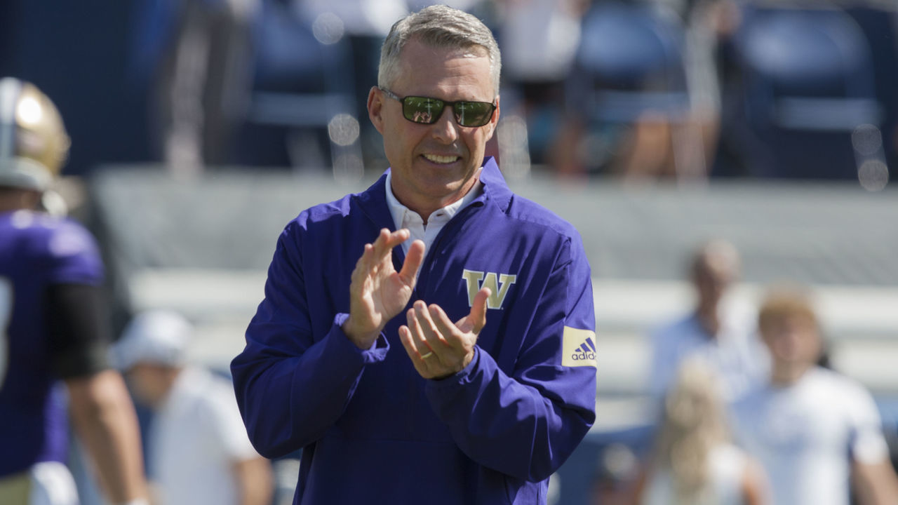 PROVO, UT - SEPTEMBER 21 : Head coach Chris Petersen of the Washington Huskies claps during warmups before their game against the BYU Cougars at LaVell Edwards Stadium on September 21, in Provo, Utah.
