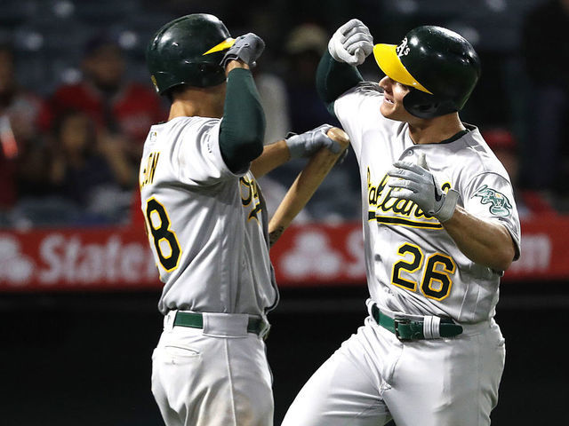 ANAHEIM, CALIFORNIA - SEPTEMBER 25: Matt Olson #28 congratulates Matt Chapman #26 of the Oakland Athletics after his two-run homerun during the eighth inning of a game against the Los Angeles Angels of Anaheim at Angel Stadium of Anaheim on September 25, 2019 in Anaheim, California.