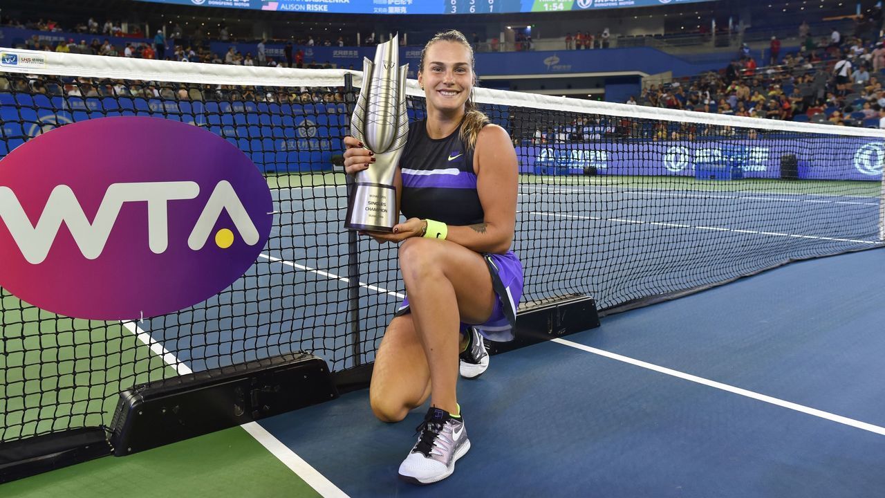 Aryna Sabalenka of Belarus poses with the trophy after her victory in the women's singles final match against Alison Riske of the US at the Wuhan Open tennis tournament in Wuhan on September 28, 2019.