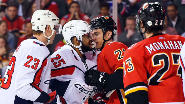 CALGARY, AB - OCTOBER 27: Washington Capitals Right Wing Devante Smith-Pelly (25) and Calgary Flames Right Wing Garnet Hathaway (21) jostle during the first period of an NHL game where the Calgary Flames hosted the Washington Capitals on October 27, 2018, at the Scotiabank Saddledome in Calgary, AB. (Brett Holmes/Icon Sportswire via Getty Images)