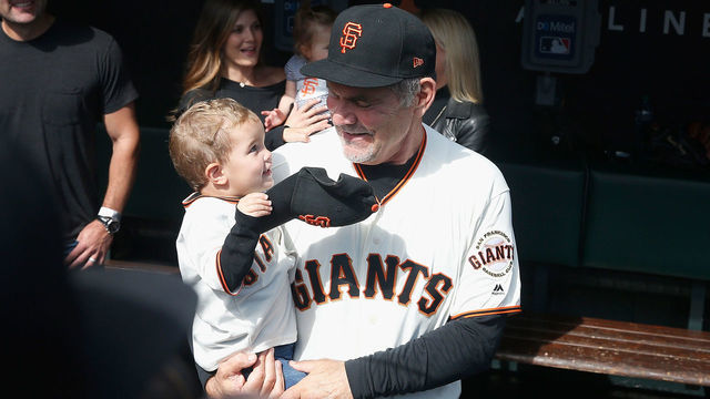 SAN FRANCISCO, CALIFORNIA - SEPTEMBER 29: Manager Bruce Bochy #15 of the San Francisco Giants stands in the dugout with his grandson before his final game as manager of the Giants, the game against the Los Angeles Dodgers at Oracle Park on September 29, 2019 in San Francisco, California.