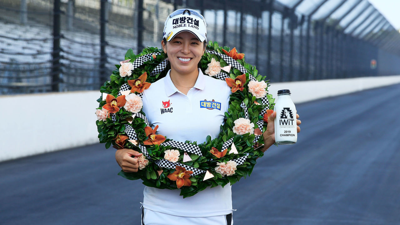 INDIANAPOLIS, IN - SEPTEMBER 29: Mi Jung Hur of the Republic of Korea poses with milk and the winners wreath at the Yard of Bricks at the Indianapolis Motor Speedway after winning the Indy Women In Tech Championship Driven by Group 1001 held at the Brickyard Crossing Golf Club on September 29, 2019 in Indianapolis, Indiana.