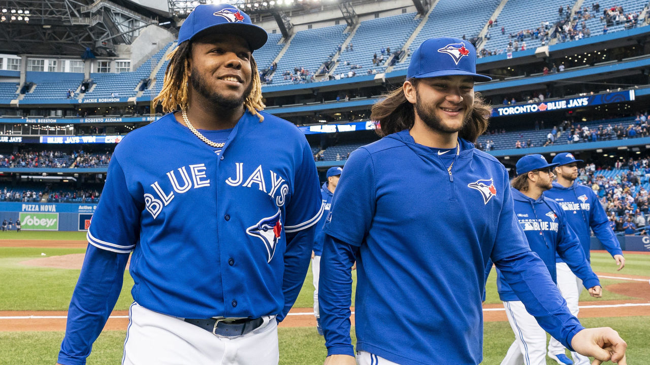 TORONTO, ONTARIO - SEPTEMBER 29: Vladimir Guerrero Jr. #27 and Bo Bichette #11 of the Toronto Blue Jays walk off the field after defeating the Tampa Bay Rays in the last game of the season in their MLB game at the Rogers Centre on September 29, 2019 in Toronto, Canada.