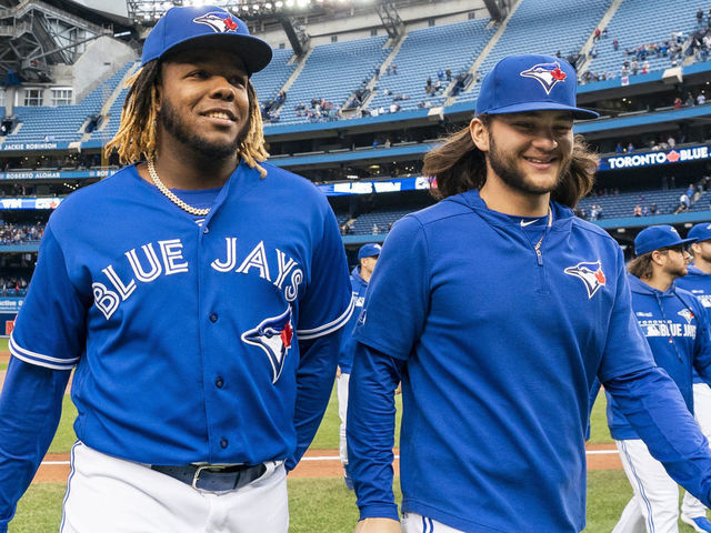 TORONTO, ONTARIO - SEPTEMBER 29: Vladimir Guerrero Jr. #27 and Bo Bichette #11 of the Toronto Blue Jays walk off the field after defeating the Tampa Bay Rays in the last game of the season in their MLB game at the Rogers Centre on September 29, 2019 in Toronto, Canada.