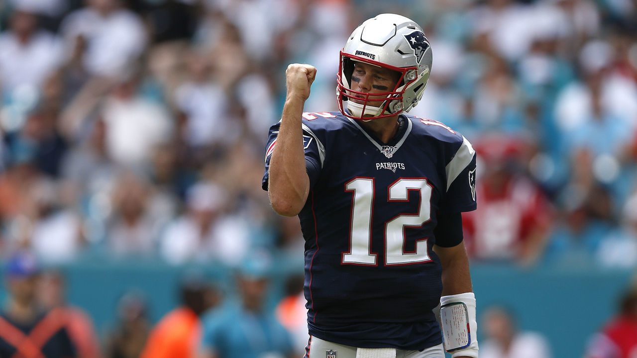 MIAMI, FLORIDA - SEPTEMBER 15: Tom Brady #12 of the New England Patriots celebrates after Sony Michel #26 scored a one yard touchdown against the Miami Dolphins during the first quarter in the game at Hard Rock Stadium on September 15, 2019 in Miami, Florida.
