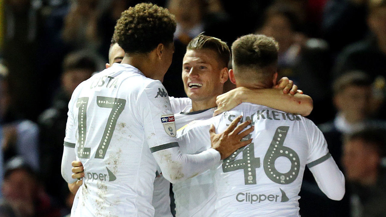 LEEDS, ENGLAND - OCTOBER 01: Leeds United's Ezgjan Alioski (centre) celebrates with team-mates Helder Costa (left) and Jamie Shackleton after scoring sides opening goal during the Sky Bet Championship match between Leeds United and West Bromwich Albion at Elland Road on October 1, 2019 in Leeds, England.