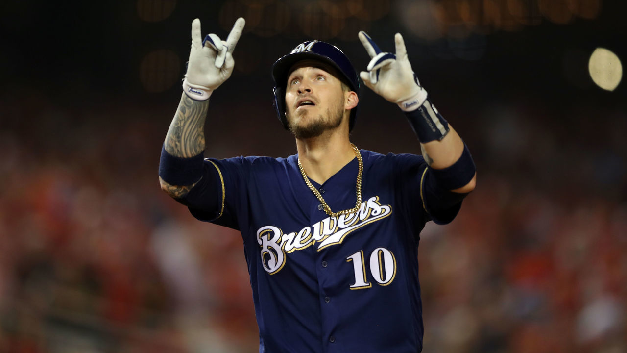 WASHINGTON, DC - OCTOBER 01: Yasmani Grandal #10 of the Milwaukee Brewers points to the sky and touches home plate after hitting a two-run home run in the first inning during the NL Wild Card game between the Milwaukee Brewers and the Washington Nationals at Nationals Park on Tuesday, October 1, 2019 in Washington, District of Columbia.