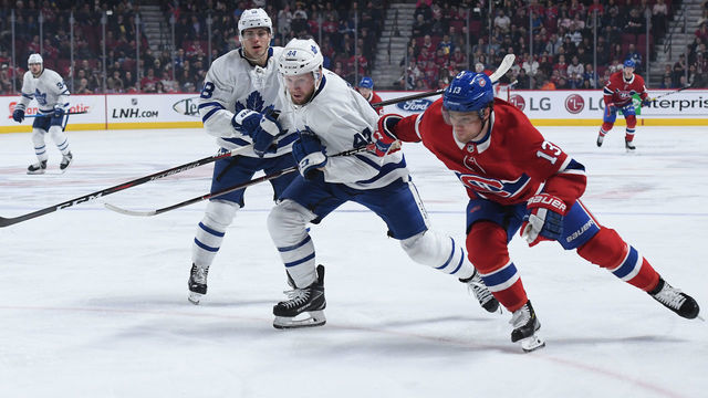 MONTREAL, QC - APRIL 6: Max Domi #13 of the Montreal Canadiens skates for the puck against Morgan Rielly #44 of the Toronto Maple Leafs in the NHL game at the Bell Centre on April 6, 2019 in Montreal, Quebec, Canada.