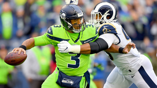 SEATTLE, WASHINGTON - OCTOBER 03: Russell Wilson #3 of the Seattle Seahawks is pressured by Aaron Donald #99 of the Los Angeles Rams during the first half of the game at CenturyLink Field on October 03, 2019 in Seattle, Washington.
