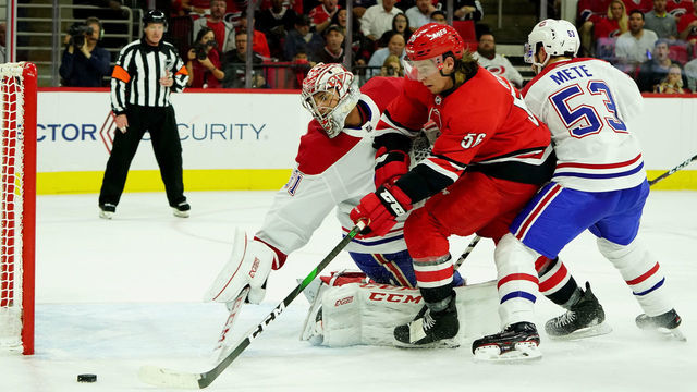 RALEIGH, NC - OCTOBER 3: Erik Haula #56 of the Carolina Hurricanes looks to chip the puck past Carey Price #31 of the Montreal Canadiens during an NHL game on October 3, 2019 at PNC Arena in Raleigh North Carolina.