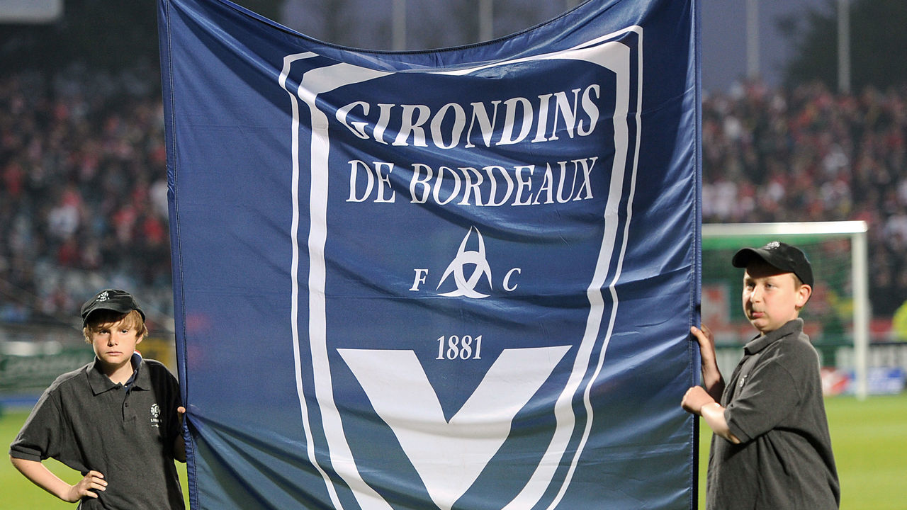 Youths hold a flag of Bordeaux football club before the French L1 football match Lille vs. Bordeaux on April 16, 2011 at Lille metropole stadium in Villeneuve d'Ascq. AFP PHOTO PHILIPPE HUGUEN
