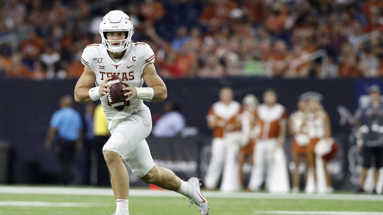 HOUSTON, TX - SEPTEMBER 14: Sam Ehlinger #11 of the Texas Longhorns rolls out to pass in the third quarter against the Rice Owls at NRG Stadium on September 14, 2019 in Houston, Texas.