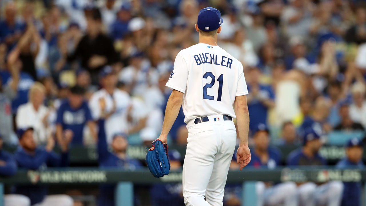 LOS ANGELES, CA - OCTOBER 03: Walker Buehler #21 of the Los Angeles Dodgers heads into the dugout between innings against the Washington Nationals during Game 1 of the NLDS at Dodger Stadium on Thursday, October 3, 2019 in Los Angeles, California.