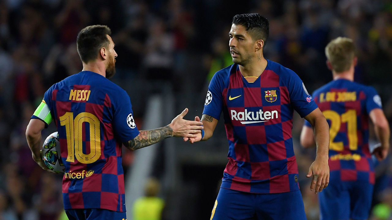 Barcelona's Uruguayan forward Luis Suarez (R) is congratulated by teammate Barcelona's Argentine forward Lionel Messi after scoring a goal during the UEFA Champions League Group F football match between Barcelona and Inter Milan at the Camp Nou stadium in Barcelona, on October 2, 2019.
