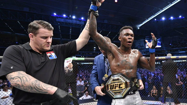 MELBOURNE, AUSTRALIA - OCTOBER 06: Israel Adesanya of Nigeria celebrates after his knockout victory over Robert Whittaker of New Zealand in their UFC middleweight championship fight during the UFC 243 event at Marvel Stadium on October 06, 2019 in Melbourne, Australia.