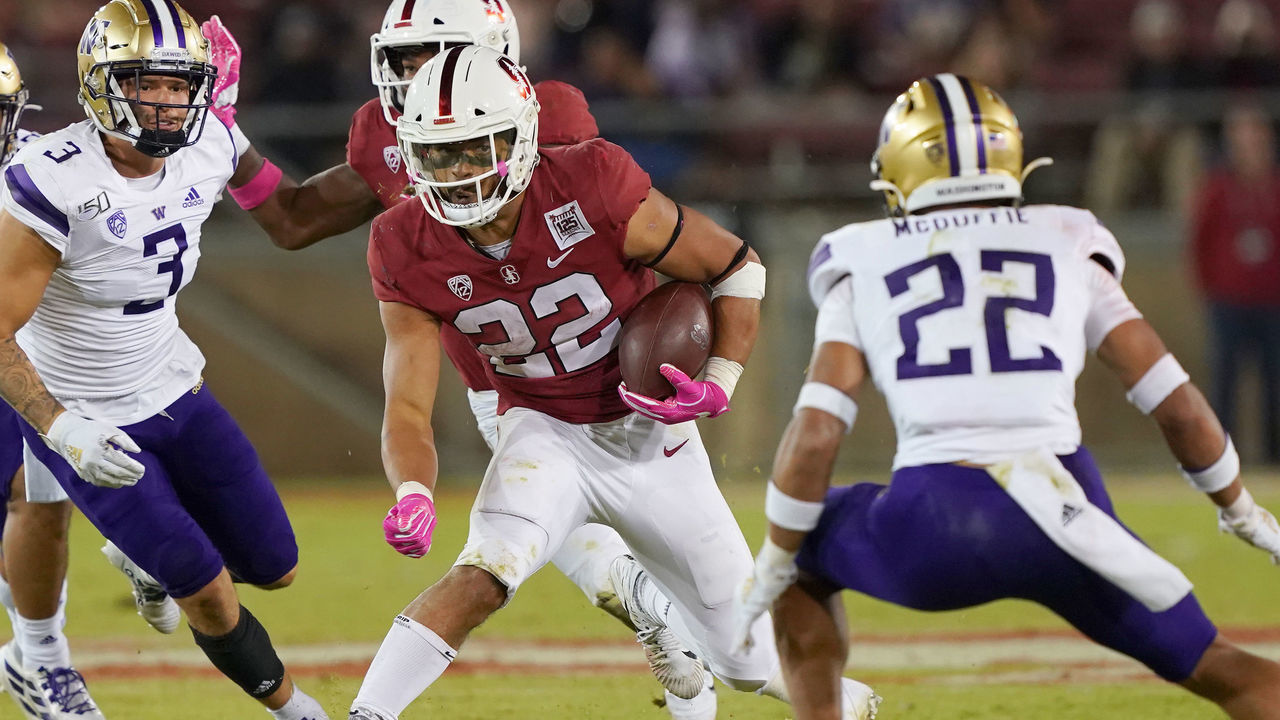 PALO ALTO, CALIFORNIA - OCTOBER 05: Cameron Scarlett #22 of the Stanford Cardinal carries the ball against the Washington Huskies during the fourth quarter of an NCAA football game at Stanford Stadium on October 05, 2019 in Palo Alto, California. Stanford won the game 23-13.