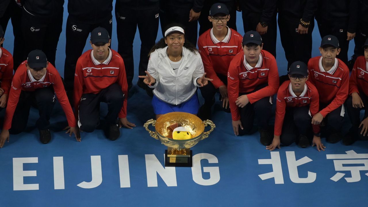 Naomi Osaka of Japan poses with the trophy after winning her women's singles final match against Ashleigh Barty of Australia at the China Open tennis tournament in Beijing on October 6, 2019.